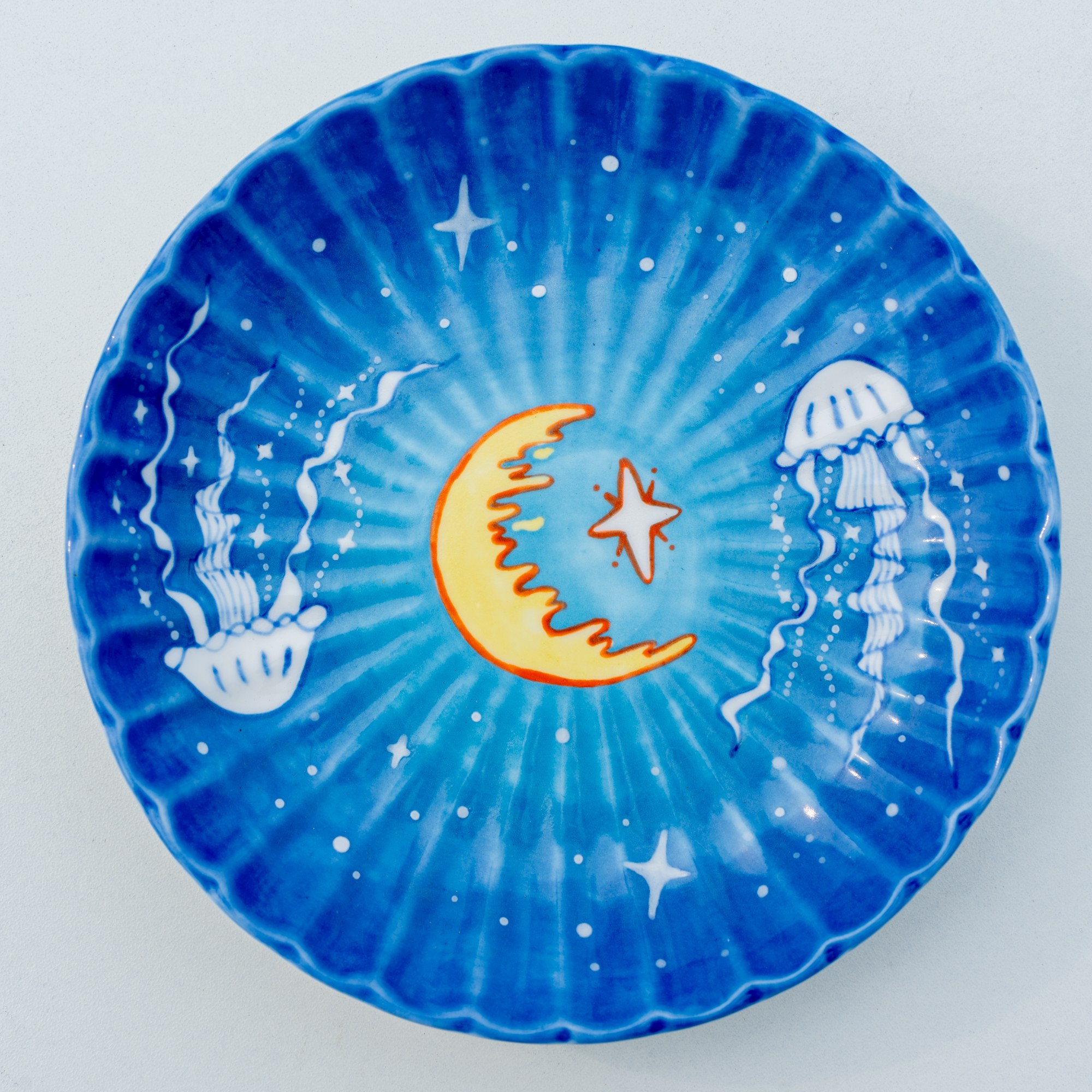 Hand-painted moon and jellyfish ocean ceramic plate with blue tones and white stars