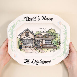 Custom house portrait plate with green botanical border, family name, and address