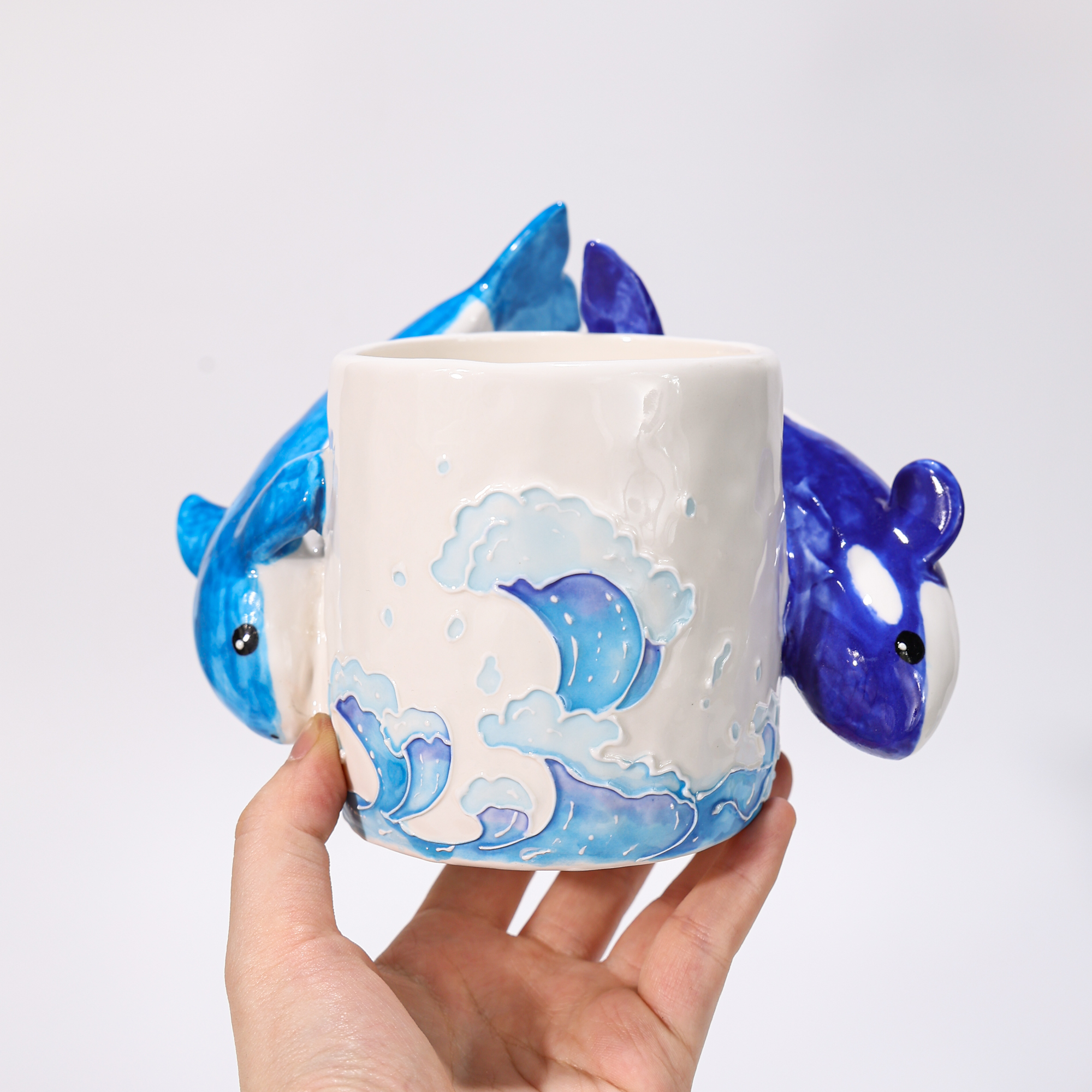 Hand-painted orca and dolphin coral reef ceramic mugs with sculptural animal handles