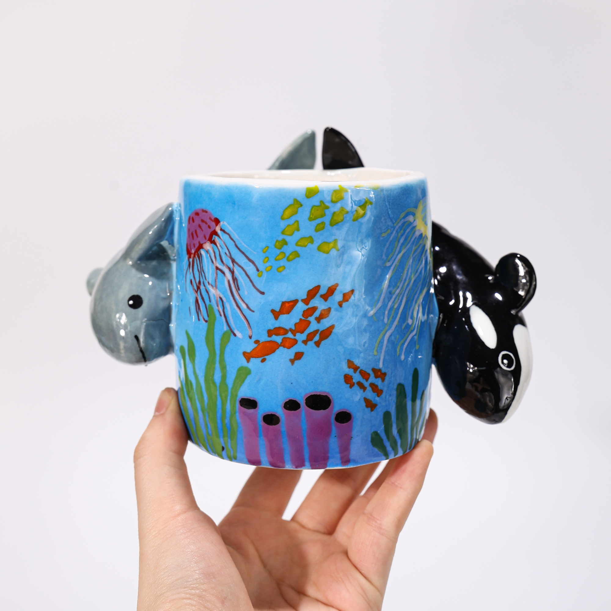 Hand-painted orca and dolphin coral reef ceramic mugs with sculptural animal handles